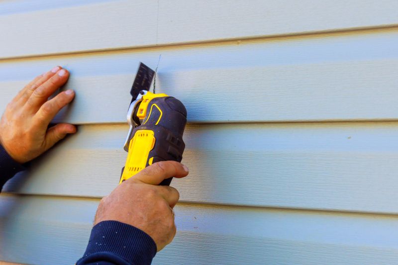 Professional Siding Installer Using Tools